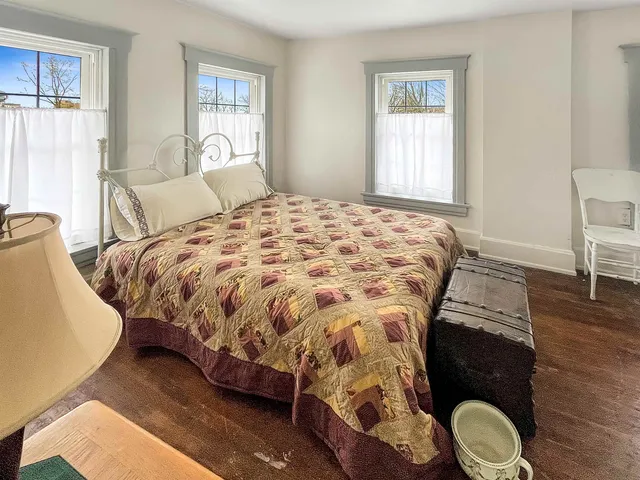 a bedroom with a bed and window