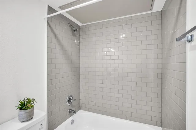 a bathroom with a shower and a toilet