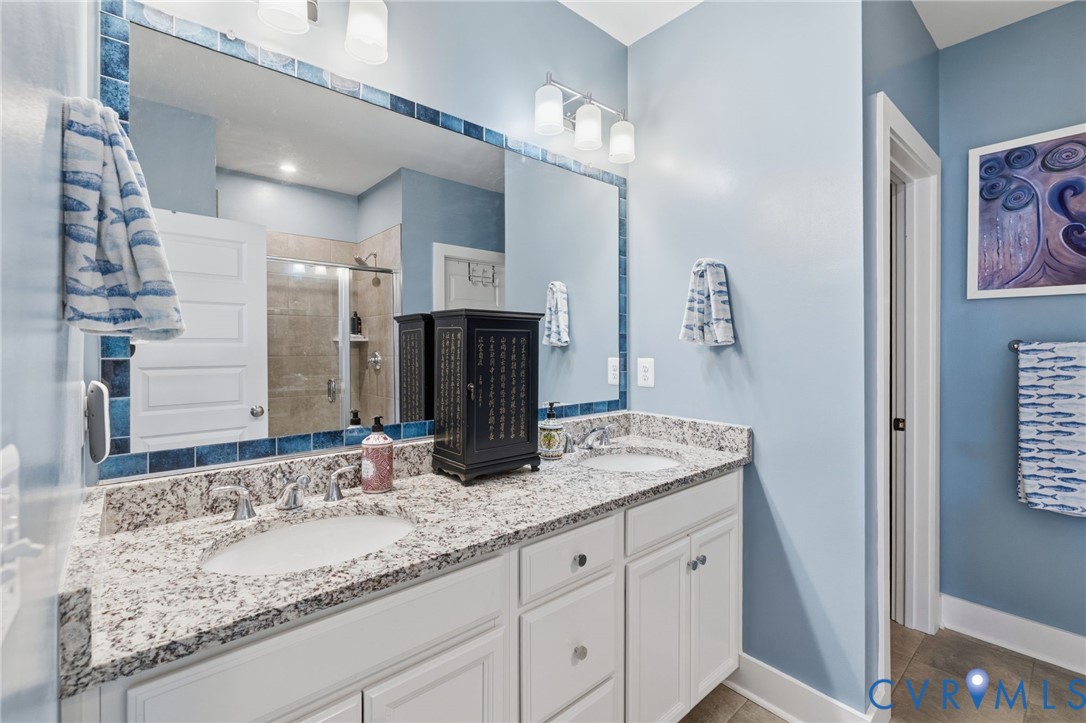 585 Hazel Place, Unit A Henrico, VA 23233 - Photo 17 of 26 a bathroom with a granite countertop sink and a mirror