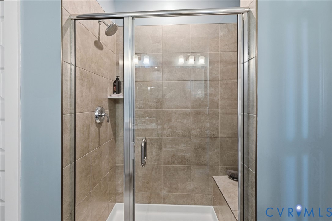 585 Hazel Place, Unit A Henrico, VA 23233 - Photo 18 of 26 a bathroom with a glass shower door