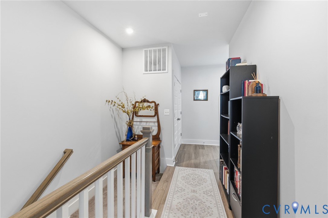 585 Hazel Place, Unit A Henrico, VA 23233 - Photo 20 of 26 a view of a hallway with wooden floor and stairs