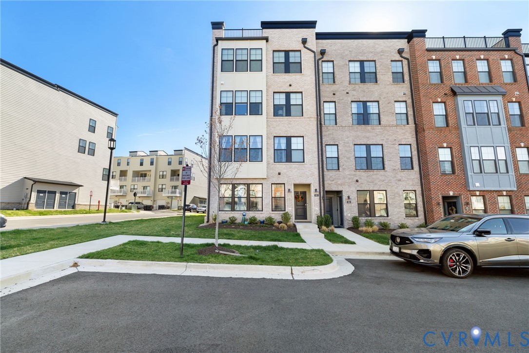 585 Hazel Place, Unit A Henrico, VA 23233 - Photo 2 of 26 a view of building with cars parked in front of it