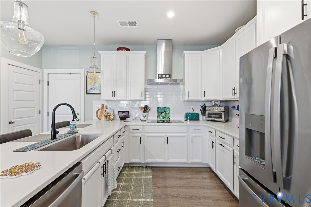 585 Hazel Place, Unit A Henrico, VA 23233 - Photo 10 of 26 a kitchen with stainless steel appliances a refrigerator sink and cabinets