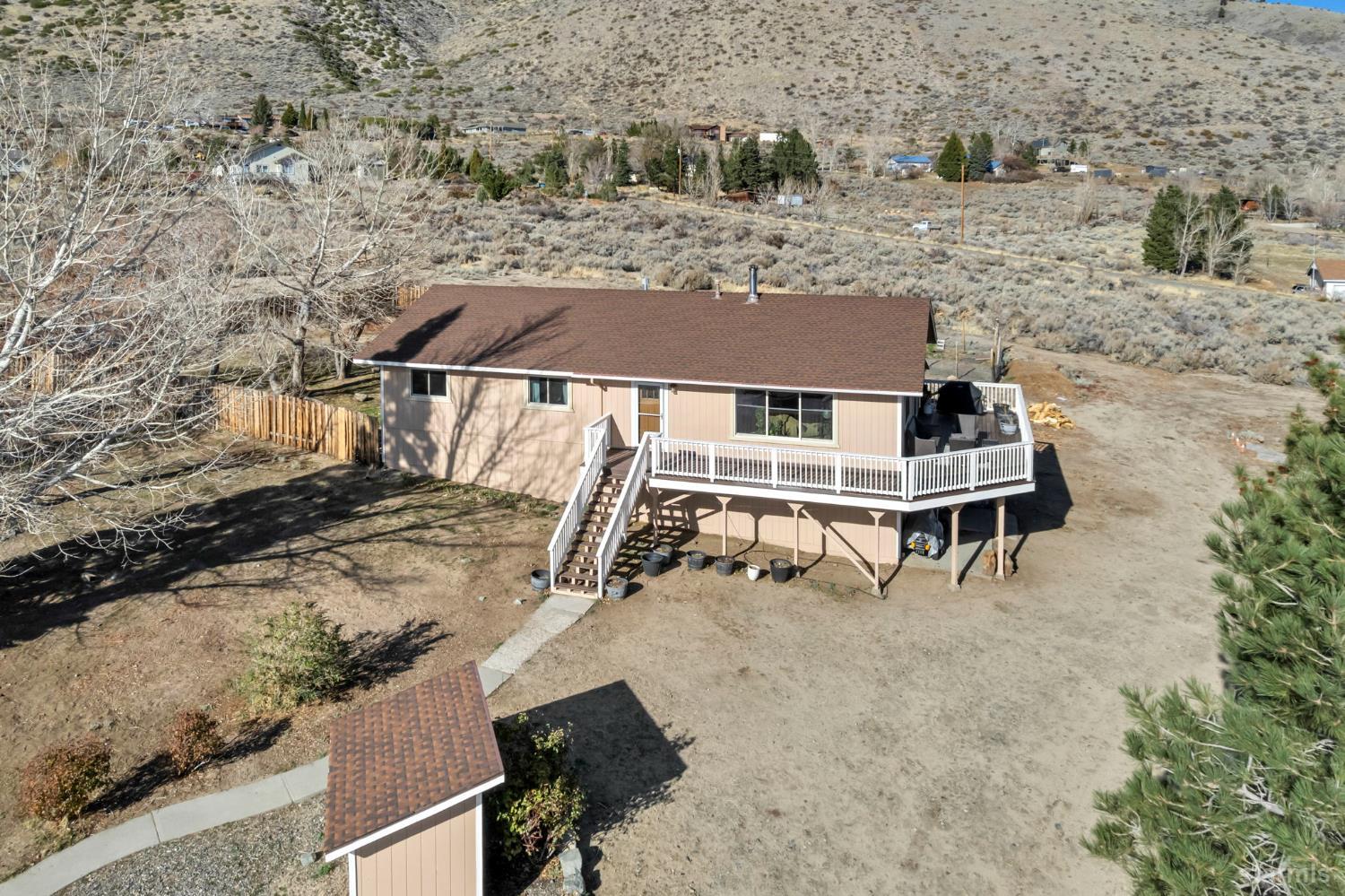 an aerial view of a house with yard