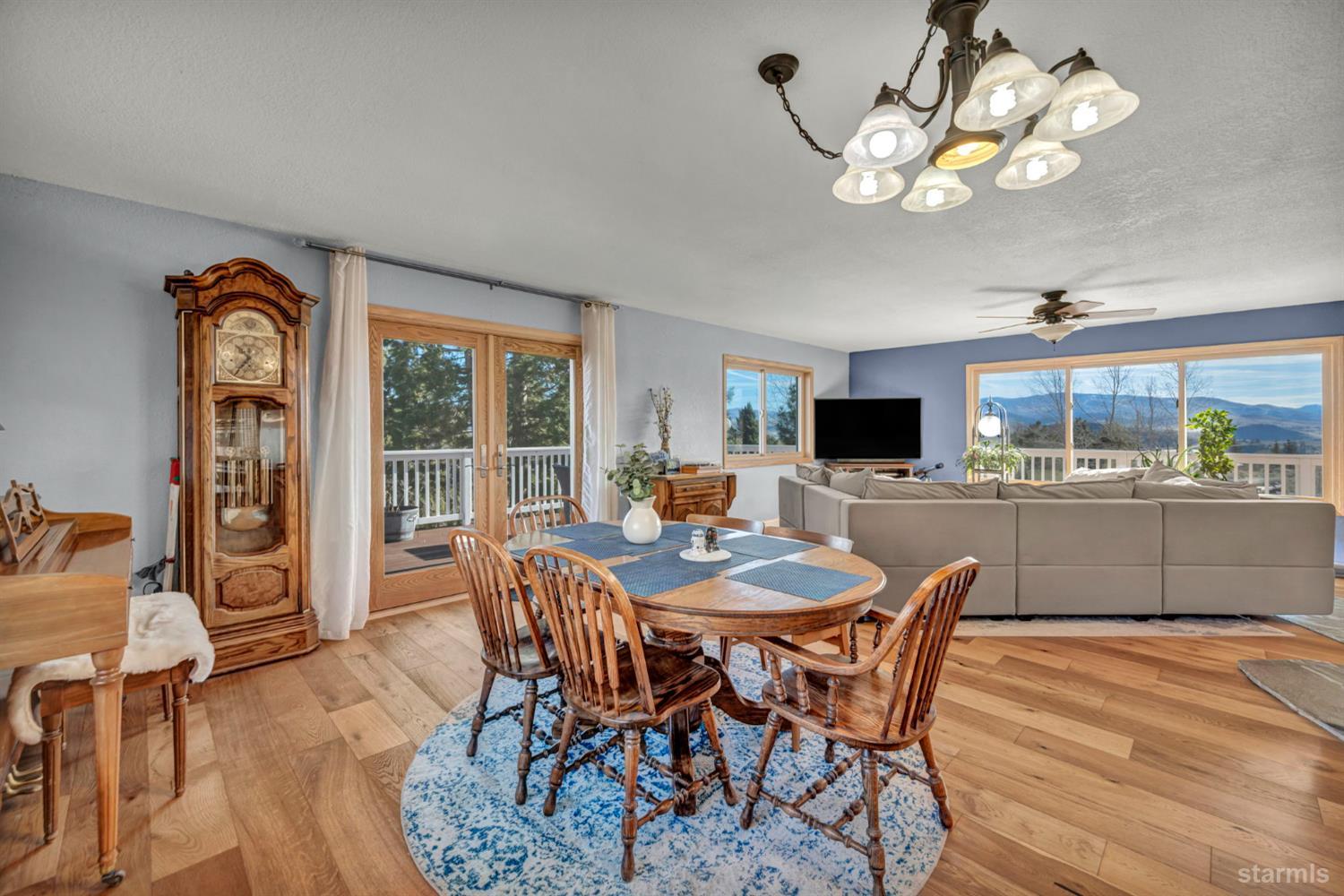 110 Carson View Markleeville, CA 96120 - Photo 12 of 39 a dining room with wooden floor a chandelier a wooden table and chairs