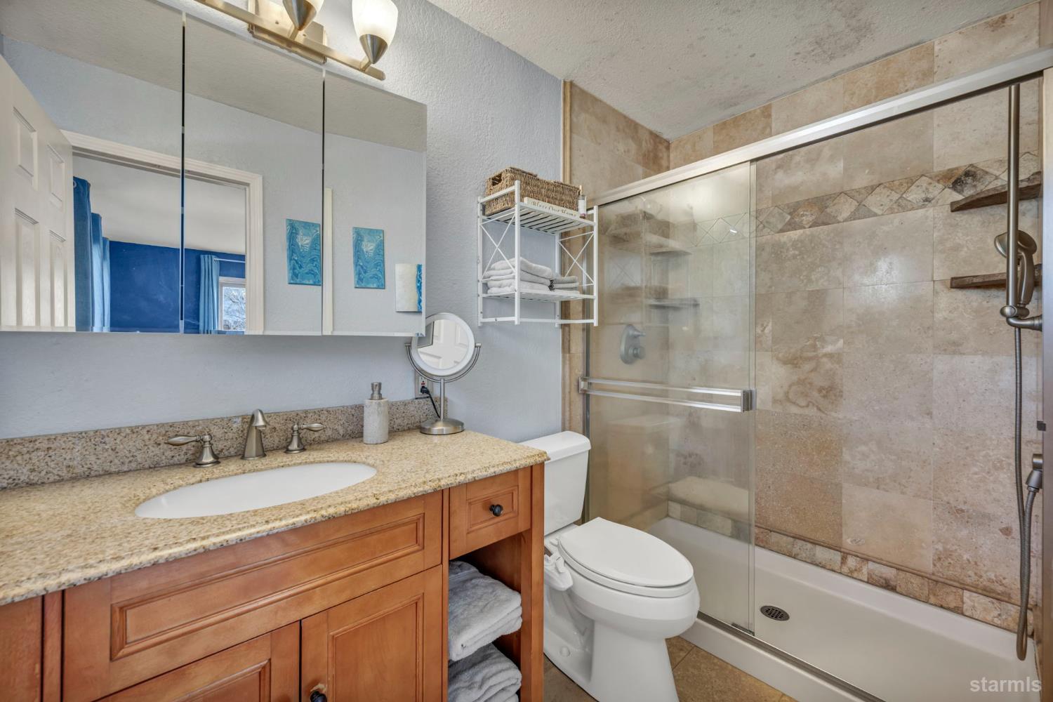 110 Carson View Markleeville, CA 96120 - Photo 28 of 39 a bathroom with a granite countertop sink toilet a mirror and shower