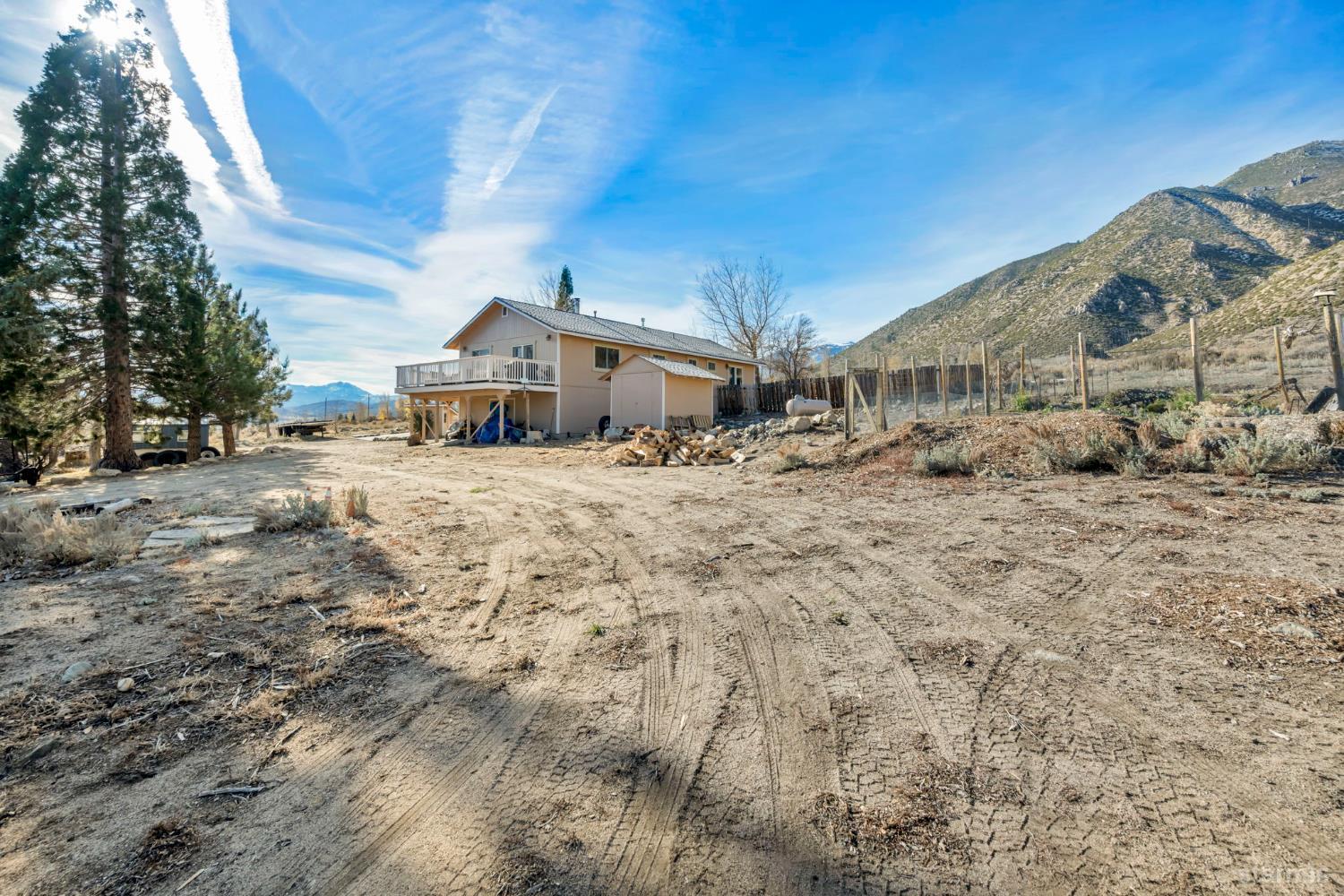 110 Carson View Markleeville, CA 96120 - Photo 33 of 39 a big room with large trees and a wooden fence