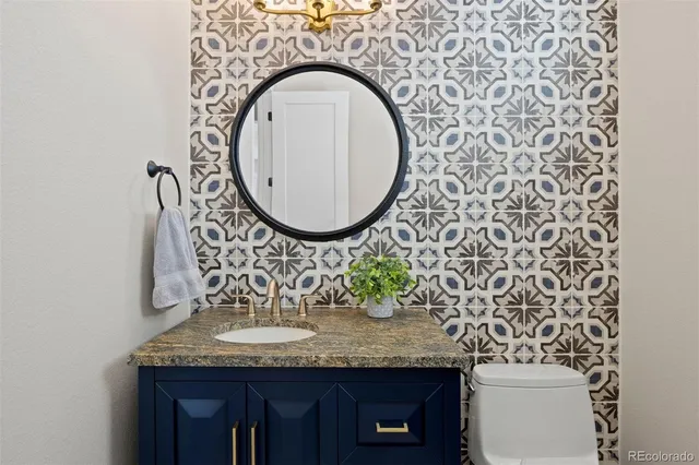 a bathroom with a granite countertop sink and a mirror