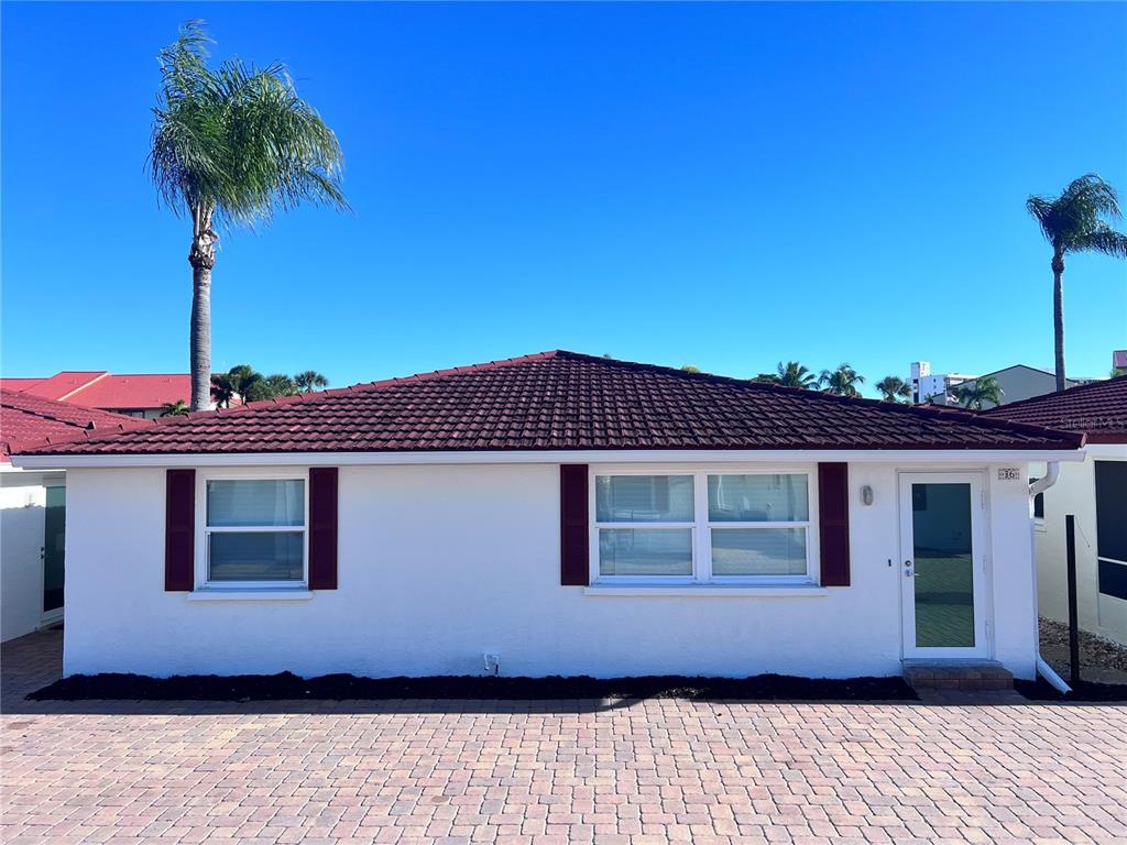 6154 Midnight Pass Road, Unit B06 Sarasota, FL 34242 - Photo 1 of 18 a front view of a house with a garden