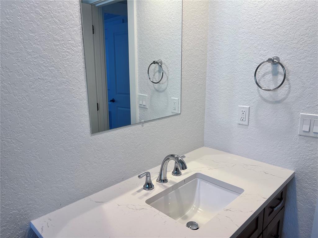 6154 Midnight Pass Road, Unit B06 Sarasota, FL 34242 - Photo 13 of 18 a bathroom with a sink and a mirror