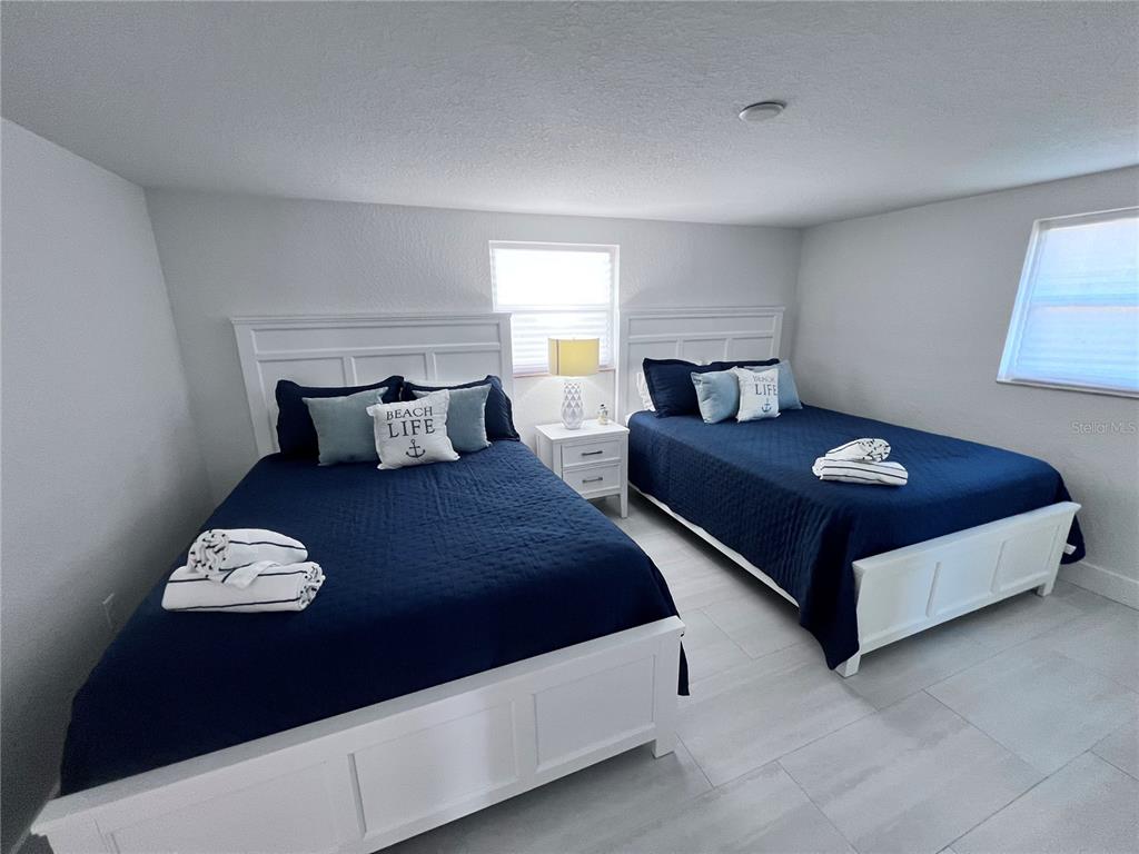 6154 Midnight Pass Road, Unit B06 Sarasota, FL 34242 - Photo 14 of 18 a bedroom with a bed and window