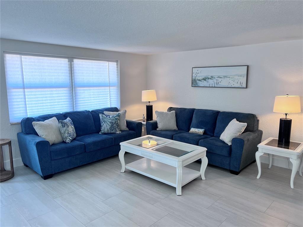 6154 Midnight Pass Road, Unit B06 Sarasota, FL 34242 - Photo 2 of 18 a living room with furniture and a window