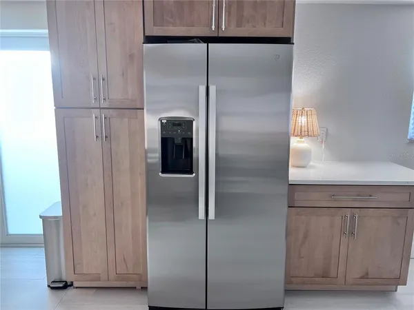 a refrigerator freezer sitting inside of a kitchen