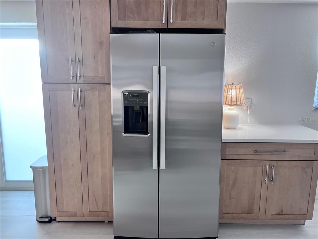 6154 Midnight Pass Road, Unit B06 Sarasota, FL 34242 - Photo 6 of 18 a refrigerator freezer sitting inside of a kitchen