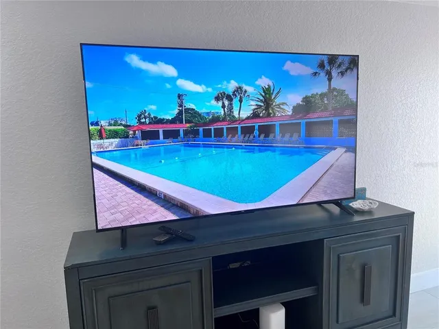 a room with pool table and chandelier