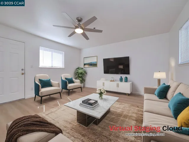 a living room with furniture and a potted plant