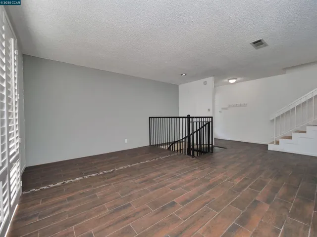 a view of hallway with wooden floor