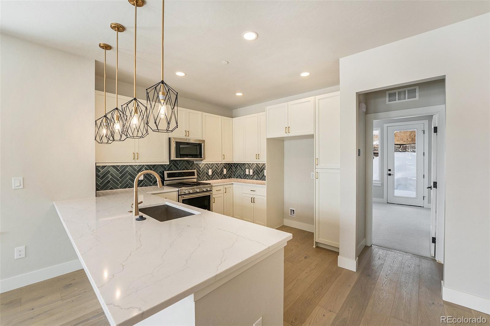 a kitchen with a refrigerator a sink and cabinets