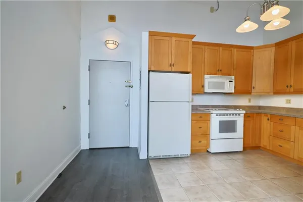 a kitchen with a refrigerator and a stove
