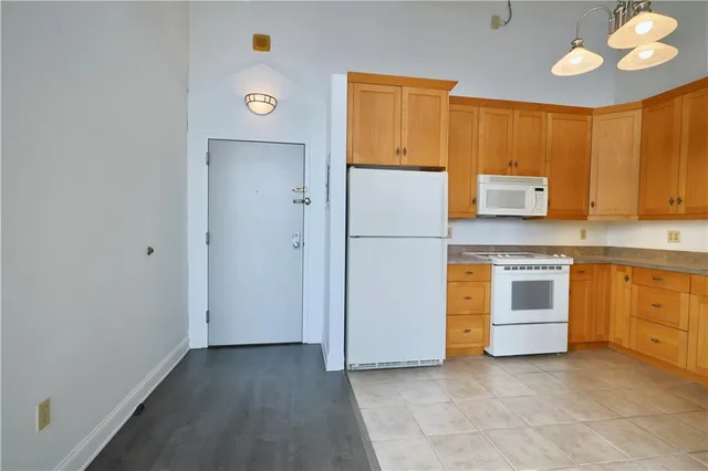 a kitchen with a refrigerator and a stove