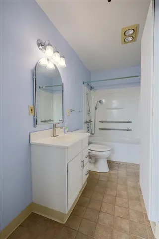 a bathroom with a sink a toilet and mirror