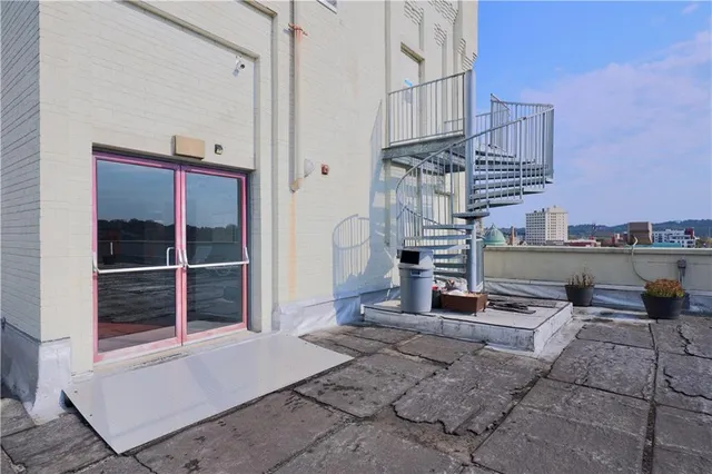 a view of a patio with a table and chairs