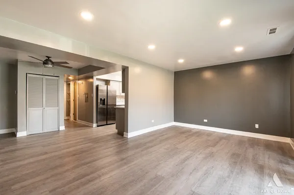 a view of an empty room with wooden floor