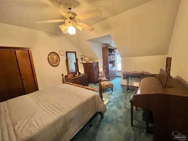 a bedroom with bed and window