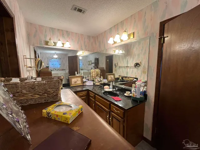 a kitchen with sink refrigerator and stove