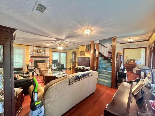 a living room with furniture fireplace and a large window