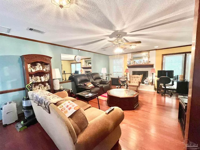 a living room with furniture a fireplace and a chandelier
