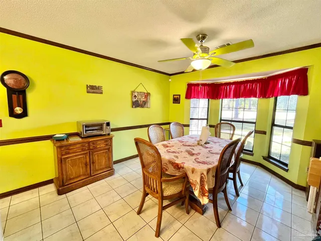 a view of a dining room with furniture and a floor to ceiling window