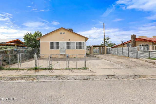 a front view of a house with a wooden fence