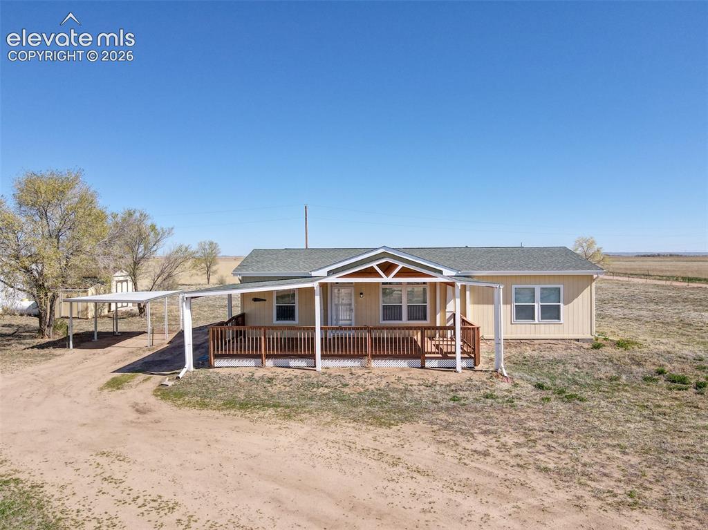 22558 Enoch Road Calhan, CO 80808 - Photo 2 of 50 a front view of a house with a yard