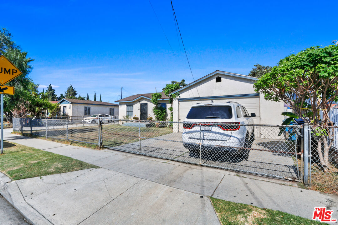 7101 Chanslor Avenue Bell, CA 90201 - Photo 2 of 20 a front view of a house with a yard