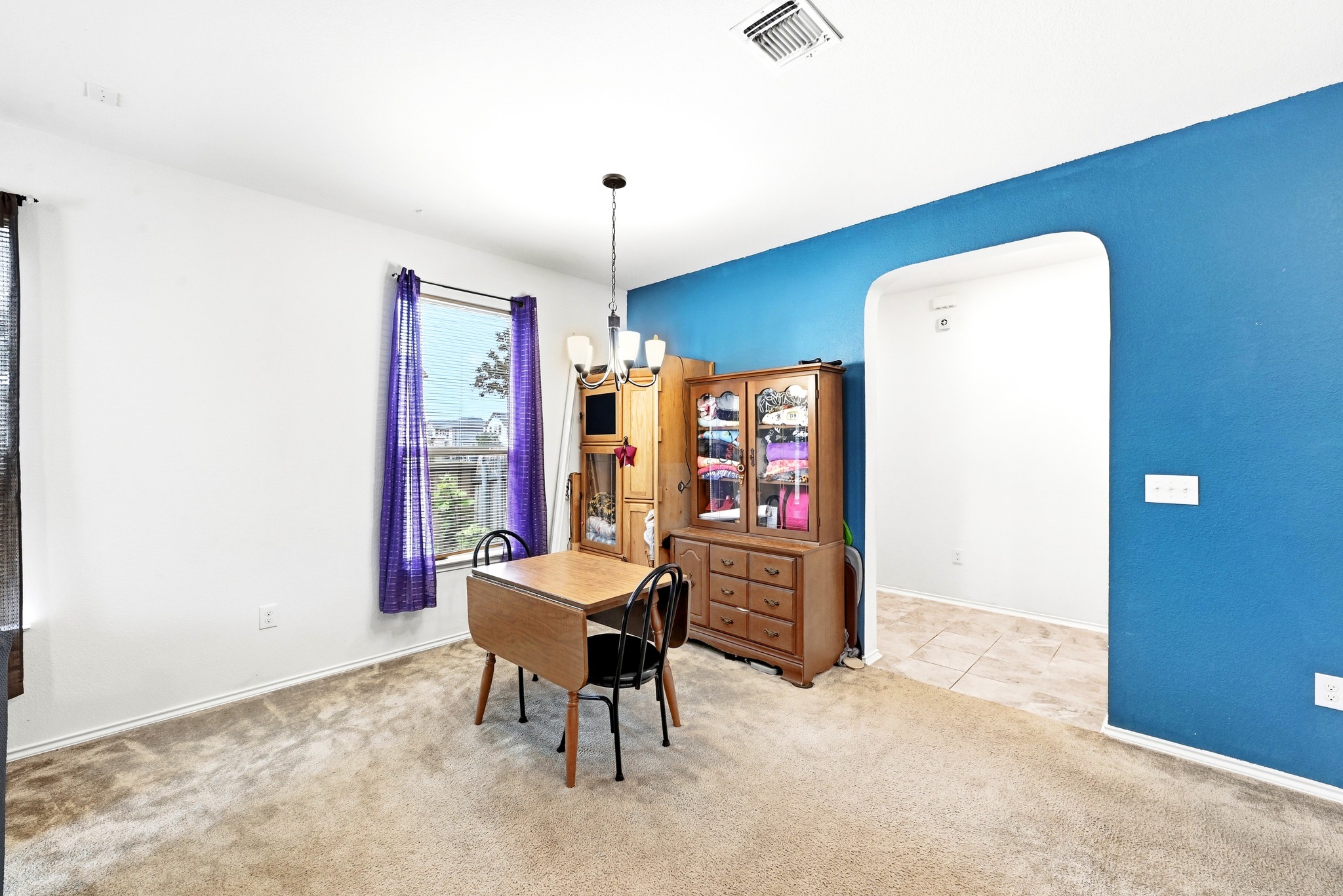 1621 Dragonfly Loop Bastrop, TX 78602 - Photo 8 of 27 Dining area featuring carpeting, a single window, and a chandelier