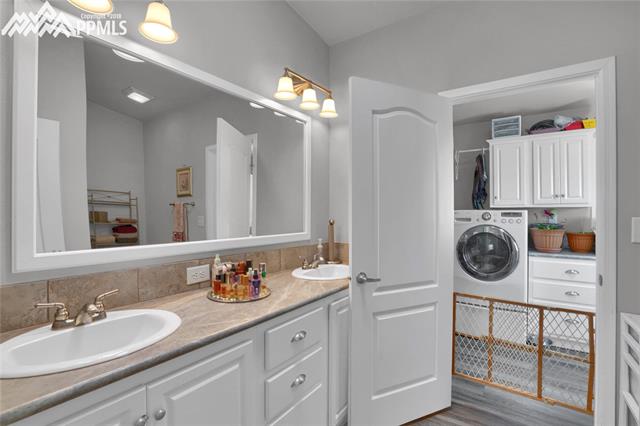 9990 North Log Road Calhan, CO 80808 - Photo 28 of 29 Master bathroom offers dual sinks, extended length counter, and lots of storage