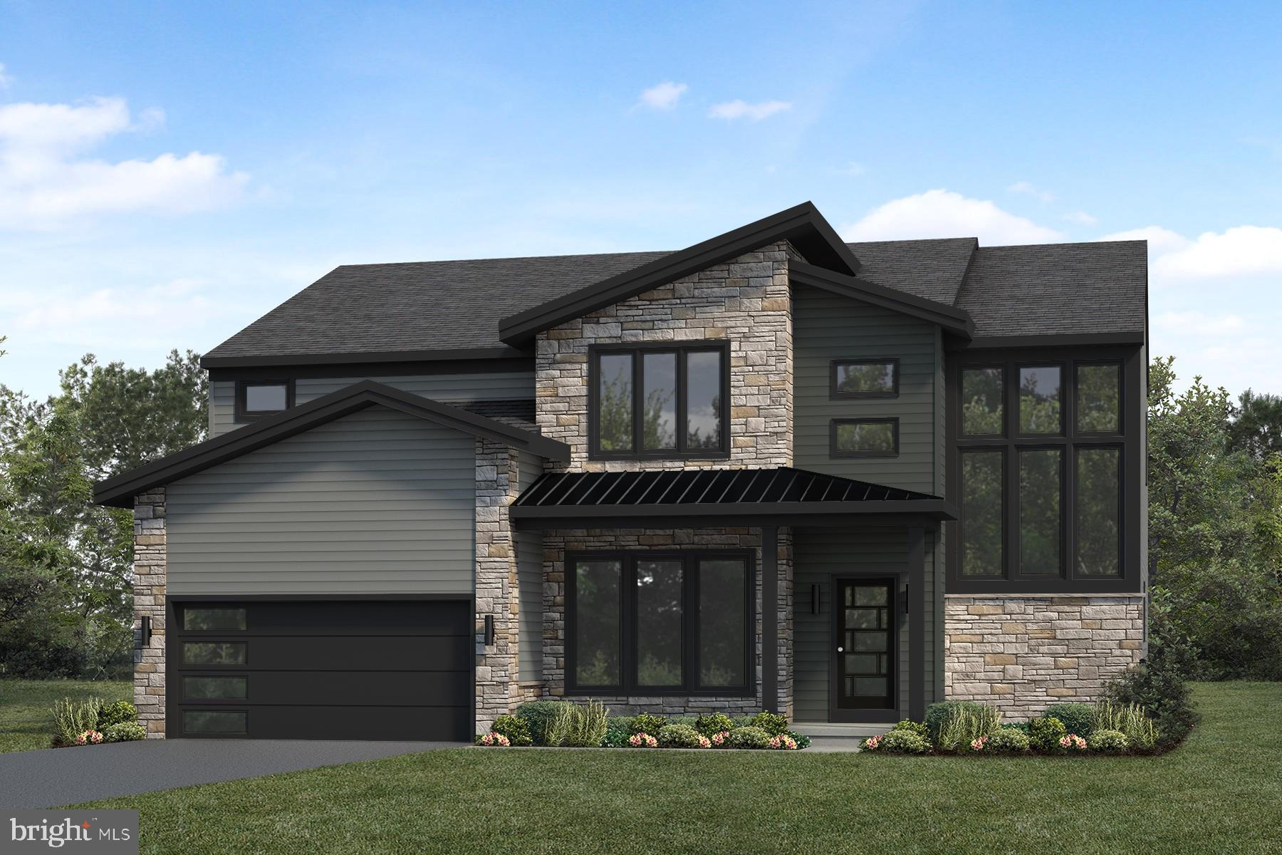 a front view of a house with a garden and yard