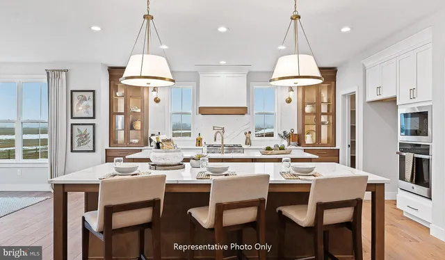 a large kitchen with a table and chairs