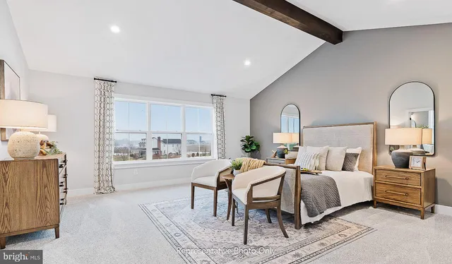 a bedroom with a bed and a dresser with mirror