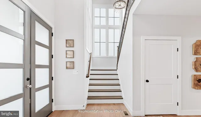 a view of staircase with wooden floor and windows