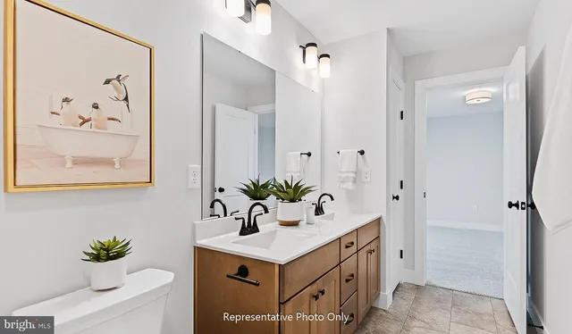 a bathroom with a sink vanity and a mirror