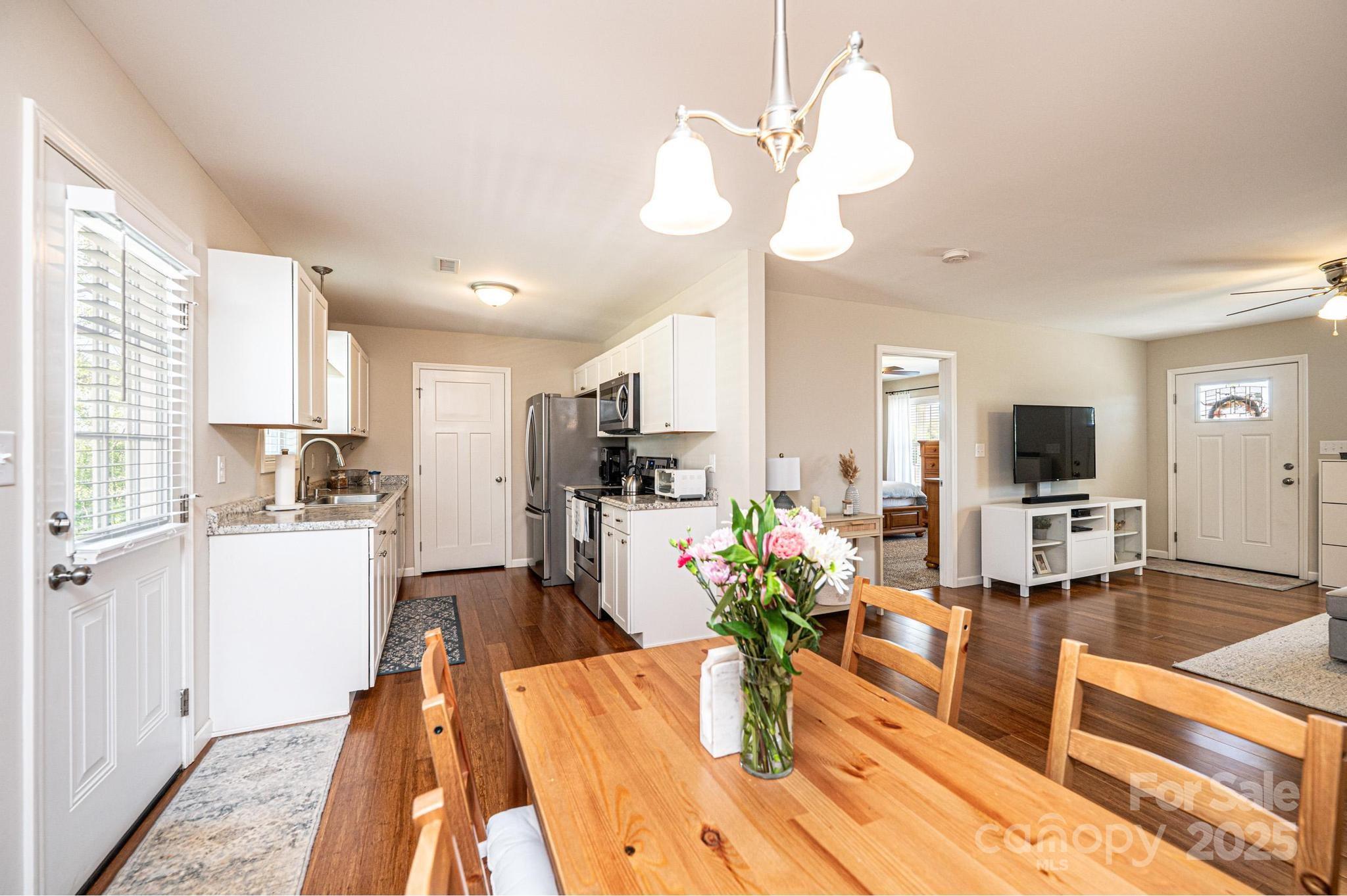 50 Serenity Lane Hickory, NC 28601 - Photo 13 of 33 a dining room with wooden floor and chandelier
