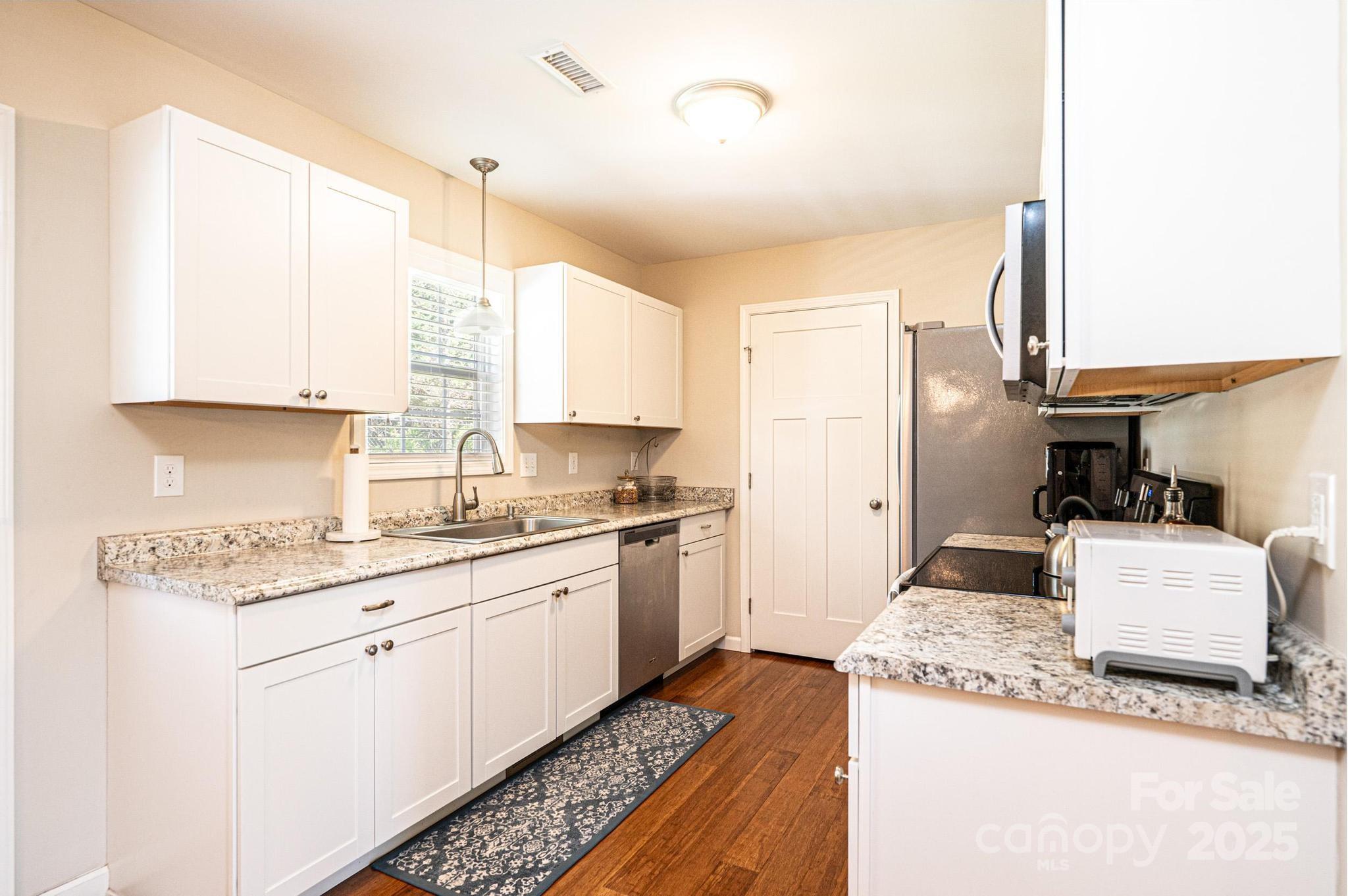 50 Serenity Lane Hickory, NC 28601 - Photo 18 of 33 a kitchen with a sink a stove and white cabinets
