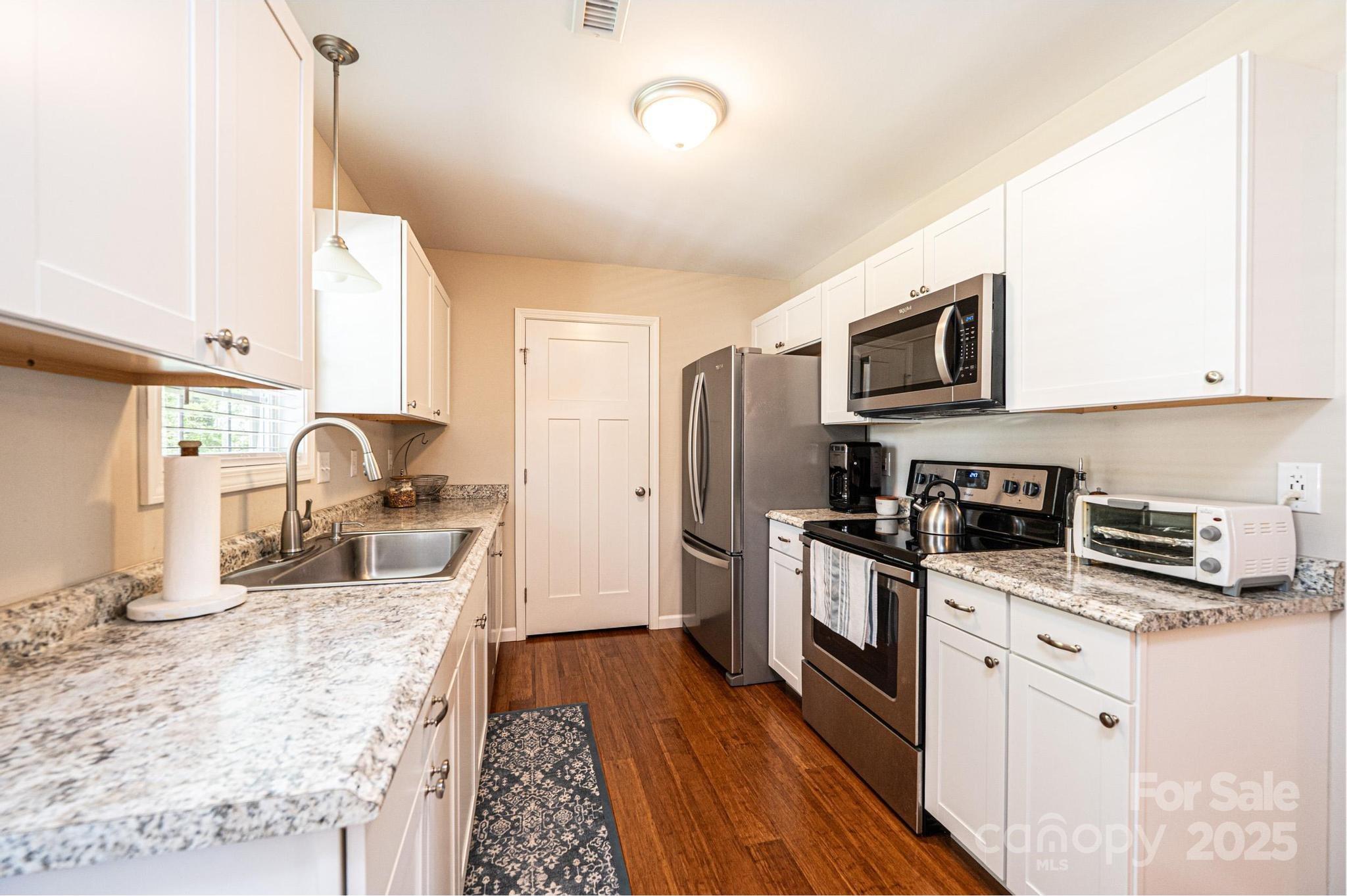 50 Serenity Lane Hickory, NC 28601 - Photo 19 of 33 a kitchen with stainless steel appliances granite countertop a sink stove and refrigerator