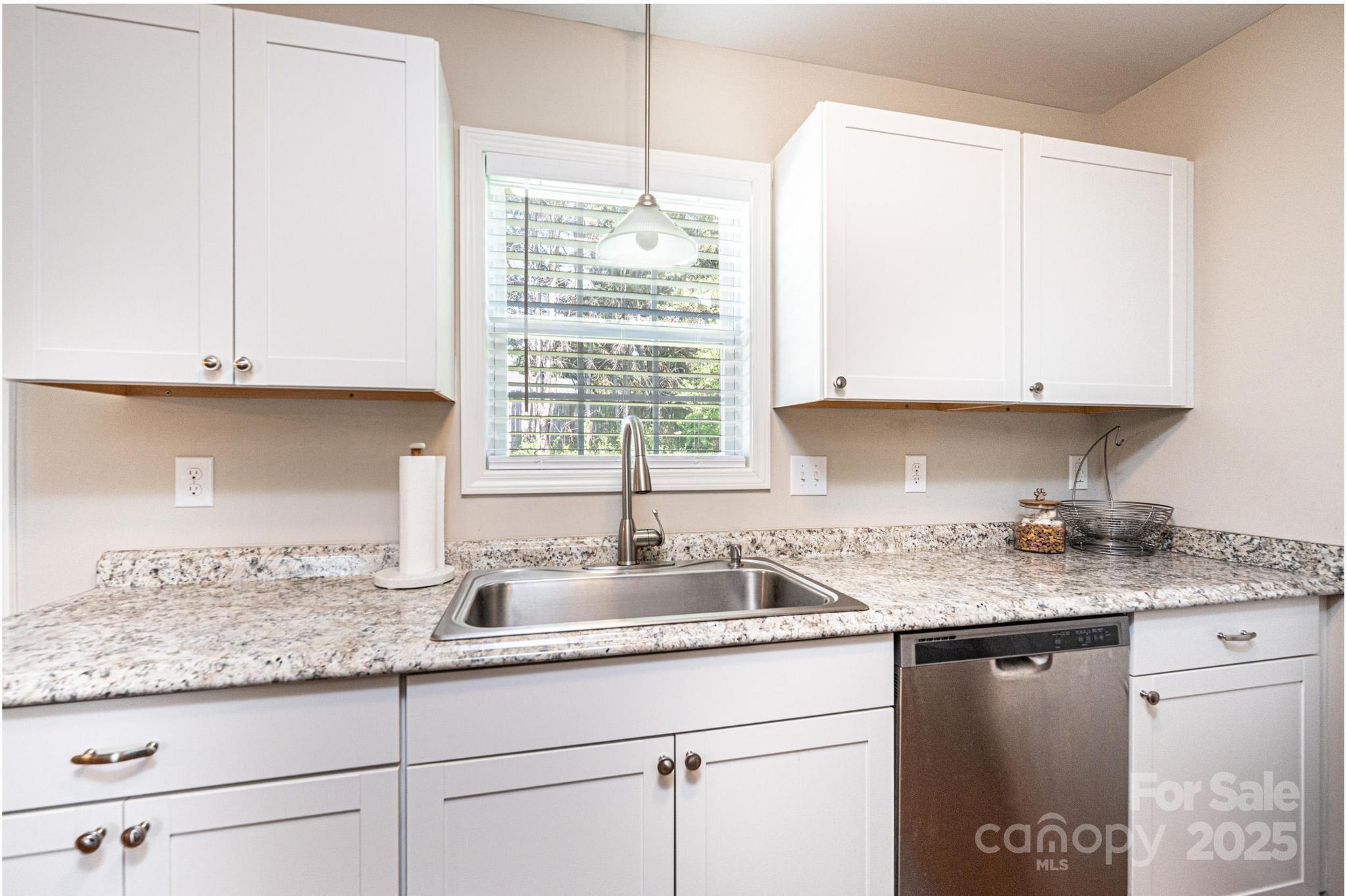 50 Serenity Lane Hickory, NC 28601 - Photo 20 of 33 a kitchen with granite countertop stainless steel appliances white cabinets granite counter tops and a wooden floors