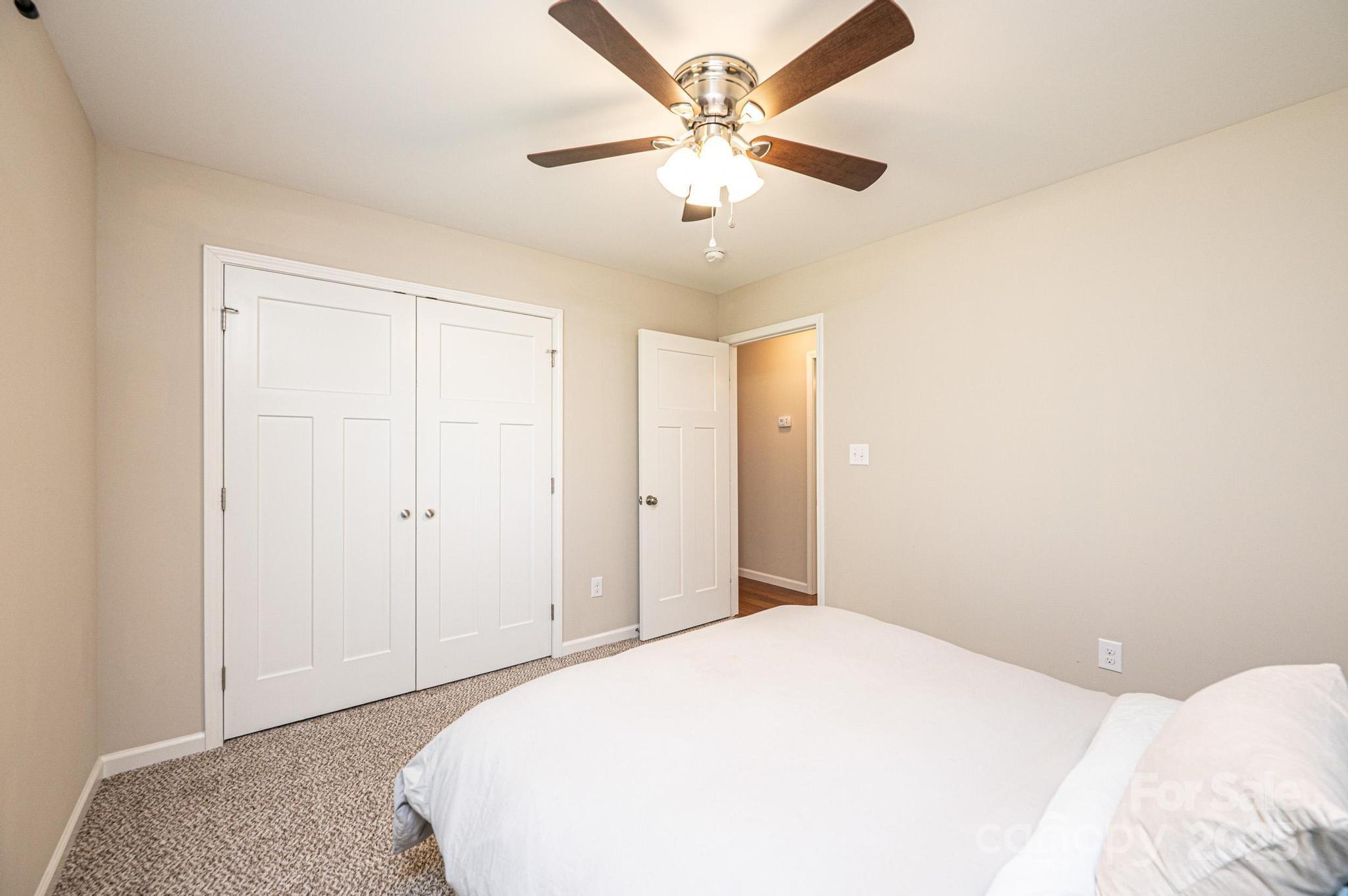 50 Serenity Lane Hickory, NC 28601 - Photo 28 of 33 a bedroom with a large bed and a chandelier