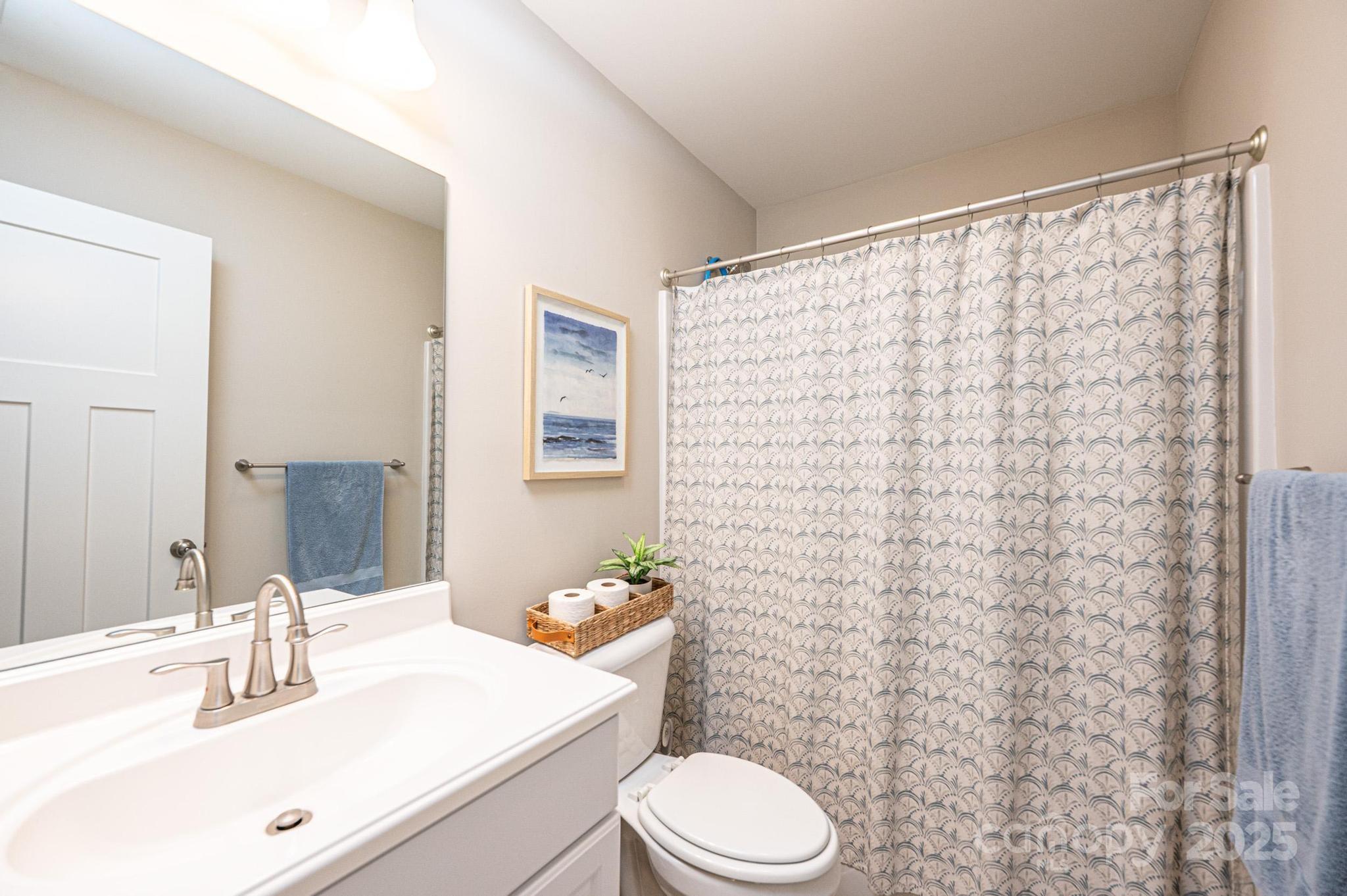 50 Serenity Lane Hickory, NC 28601 - Photo 29 of 33 a bathroom with a sink a toilet and shower curtain