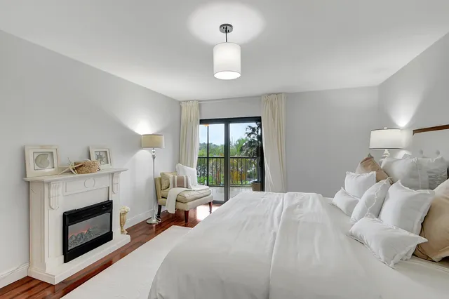 a bedroom with furniture and a fireplace