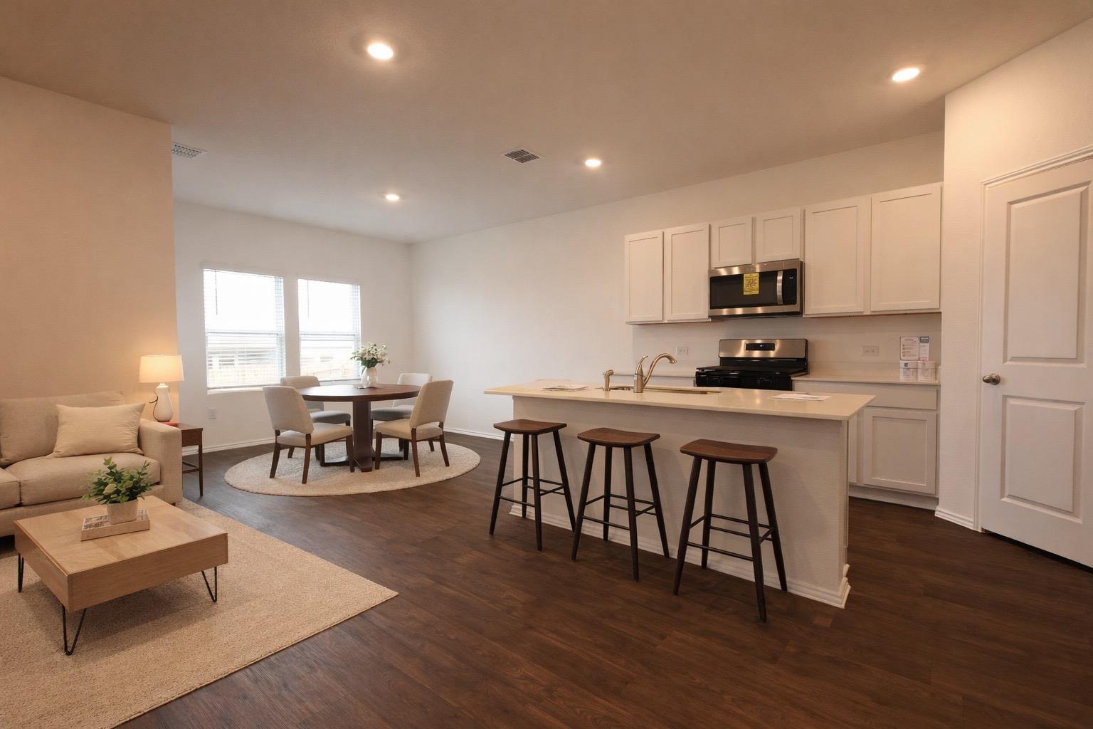 12306 Bulldogger Bend Buda, TX 78610 - Photo 3 of 11 a kitchen with stainless steel appliances granite countertop a dining table chairs stove a refrigerator and cabinets